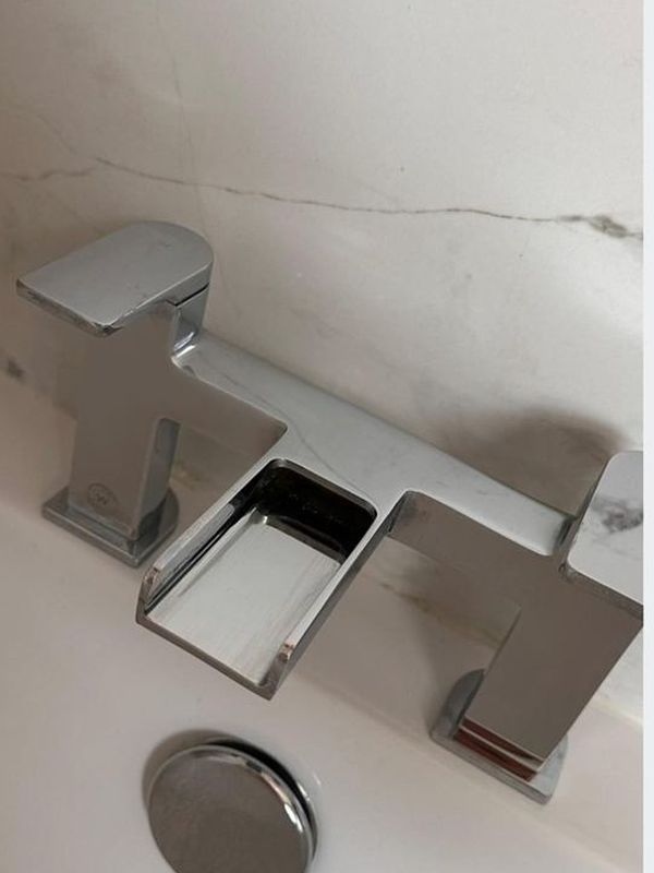 After: the bathroom mixer taps polished to a chrome shine