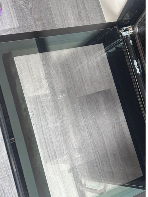 After: the glass shower screen polished back to clear glass