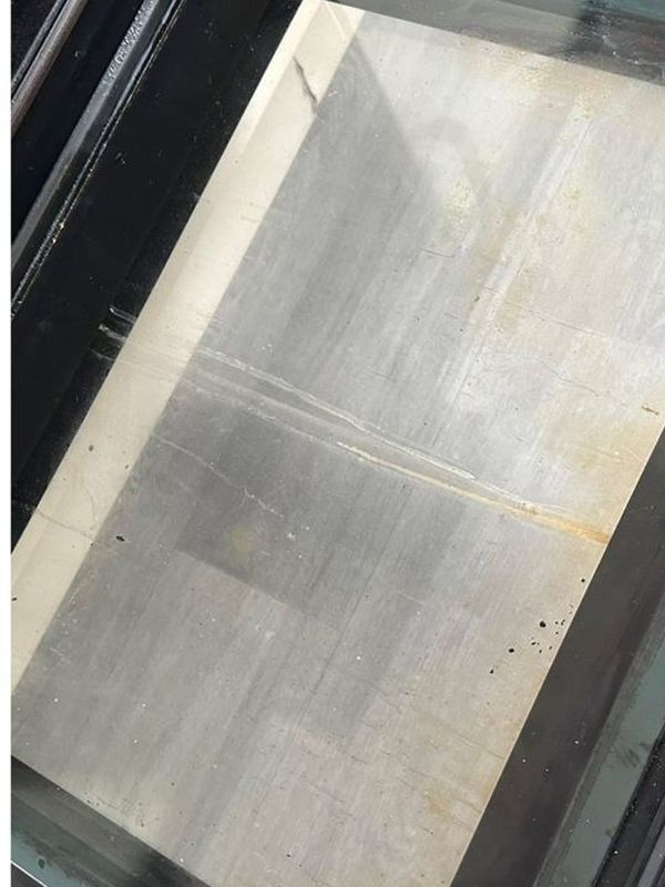 Before: the glass shower screen clouded with limescale