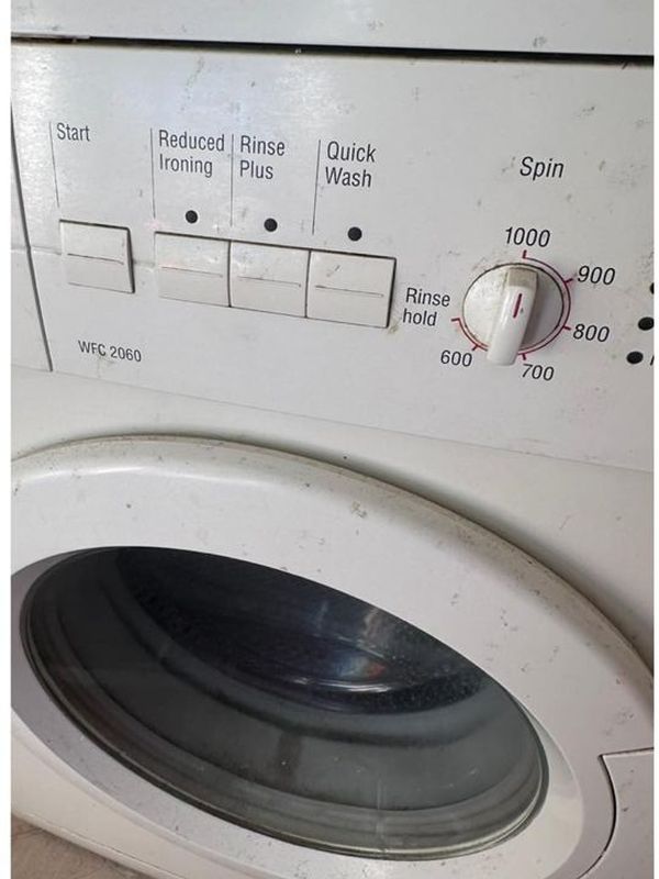 Before: the washing machine door and seal with built-up grime